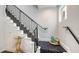 Elegant staircase with black railing and decorative stair runner and wood flooring at 235 Cocoanut Ave # 108B, Sarasota, FL 34236