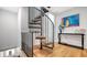 Spiral staircase featuring wood steps and an iron railing plus interior decor at 235 Cocoanut Ave # 108B, Sarasota, FL 34236