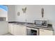 Wet bar with stainless steel appliances, granite counters, and modern cabinets at 235 Cocoanut Ave # 108B, Sarasota, FL 34236