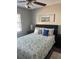 Comfortable bedroom with soft lighting, ceiling fan, and a beach themed decorative painting at 2726 Knoll E St, Palm Harbor, FL 34683