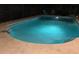 Sparkling in-ground pool illuminated at night, perfect for relaxation and outdoor enjoyment at 2726 Knoll E St, Palm Harbor, FL 34683