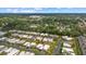 Sprawling aerial view showcases rows of cozy residences surrounded by lush greenery and well-manicured lawns at 2749 Riverbluff Pl # V65, Sarasota, FL 34231