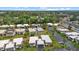 An aerial view of well-maintained residences, green lawns, and palm trees, showcasing the community's inviting atmosphere at 2749 Riverbluff Pl # V65, Sarasota, FL 34231
