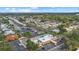 This aerial view showcases a waterfront community with lush landscaping, a canal, and a variety of boats docked at 2749 Riverbluff Pl # V65, Sarasota, FL 34231