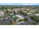 Aerial view of a neighborhood featuring single-story homes, a pool, shuffleboard and a marina at 2749 Riverbluff Pl # V65, Sarasota, FL 34231