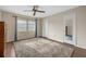 Neutral bedroom featuring a ceiling fan, large window and neutral colors at 2749 Riverbluff Pl # V65, Sarasota, FL 34231
