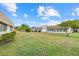 Manicured lawns with single-story homes featuring mature landscaping, and sidewalks at 2749 Riverbluff Pl # V65, Sarasota, FL 34231