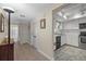 Bright hallway with tile floors leading to a well-lit kitchen and a bathroom at 2749 Riverbluff Pl # V65, Sarasota, FL 34231