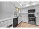 Clean kitchen featuring stainless steel appliances, white cabinets, and ample counter space at 2749 Riverbluff Pl # V65, Sarasota, FL 34231