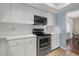 Kitchen featuring stainless steel appliances, white cabinets, and ample counter space at 2749 Riverbluff Pl # V65, Sarasota, FL 34231