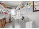 Laundry room featuring washer, dryer, sink, shelving, window and tiled floor at 2749 Riverbluff Pl # V65, Sarasota, FL 34231