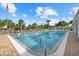 Relaxing community pool area with crystal clear water, plenty of lounge chairs, and lush tropical surroundings at 2749 Riverbluff Pl # V65, Sarasota, FL 34231