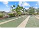 Active shuffleboard courts surrounded by green landscaping, perfect for a friendly game and enjoying the outdoors at 2749 Riverbluff Pl # V65, Sarasota, FL 34231