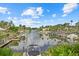 This serene waterfront view showcases a tranquil canal lined with docks and lush greenery, offering a peaceful retreat at 2749 Riverbluff Pl # V65, Sarasota, FL 34231
