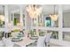 Elegantly decorated dining room with a modern chandelier and mirrored walls, perfect for entertaining at 3607 Santa Caterina Blvd, Bradenton, FL 34211
