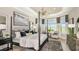 Luxurious main bedroom featuring a four-poster bed, tray ceiling, and large windows with a view at 3607 Santa Caterina Blvd, Bradenton, FL 34211