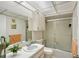 Bright bathroom features a shower/tub combination with sliding glass doors at 3705 S School Ave # 3, Sarasota, FL 34239
