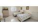 Bright bedroom features two twin beds, tile flooring, and closet at 3705 S School Ave # 3, Sarasota, FL 34239