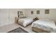 This bedroom features two twin beds, tile flooring, and closet at 3705 S School Ave # 3, Sarasota, FL 34239