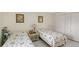 Bright bedroom features two twin beds, tile flooring, and closet at 3705 S School Ave # 3, Sarasota, FL 34239