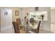 Cozy dining area with glass table and pass-through to the kitchen, creating an open feel at 3705 S School Ave # 3, Sarasota, FL 34239