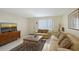 Warm living room with comfortable seating, decorative rug, and bright window, creating an inviting atmosphere at 3705 S School Ave # 3, Sarasota, FL 34239