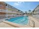 Community pool sits between two buildings with a view of a sunny sky at 3705 S School Ave # 3, Sarasota, FL 34239