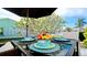 Charming outdoor dining area featuring a table setting under a shade umbrella with picturesque community views at 3911 39Th W Ave, Bradenton, FL 34205