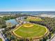 Aerial view of the community baseball fields with lake and trees at 3924 Candia Ave, North Port, FL 34286
