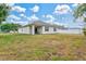 Spacious backyard with lush green grass and a covered patio at 3924 Candia Ave, North Port, FL 34286