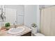 Clean bathroom with a vanity, toilet, and shower with curtain rod at 3924 Candia Ave, North Port, FL 34286
