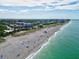 Aerial view of the beach with oceanfront condos, lifeguard station and clear blue ocean at 3924 Candia Ave, North Port, FL 34286