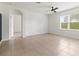 Bright bedroom with large windows, tile flooring, and a ceiling fan at 3924 Candia Ave, North Port, FL 34286