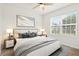 Brightly lit bedroom with modern decor, a large window, and neutral bedding at 3924 Candia Ave, North Port, FL 34286