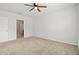 Empty bedroom with neutral carpet, a ceiling fan, and an ensuite bathroom at 3924 Candia Ave, North Port, FL 34286