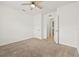 Neutral bedroom with a ceiling fan, open closet doors, and adjoining bathroom at 3924 Candia Ave, North Port, FL 34286
