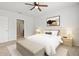 Stylishly furnished bedroom with neutral tones, comfortable bedding, and a view into the ensuite bathroom at 3924 Candia Ave, North Port, FL 34286