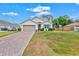 Well-maintained single-story home featuring a two-car garage, lush lawn, and beautiful landscaping at 3924 Candia Ave, North Port, FL 34286