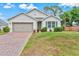 Charming single-story home with a well-manicured lawn and a brick-paved driveway at 3924 Candia Ave, North Port, FL 34286