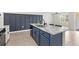 Open-concept kitchen featuring a marble island with seating, stainless steel sink, and modern design at 3924 Candia Ave, North Port, FL 34286