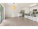 Bright kitchen featuring stainless steel appliances, a breakfast bar with seating, and tile flooring at 3924 Candia Ave, North Port, FL 34286