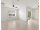 Open-concept living room with tile flooring, a large window, and a sliding glass door at 3924 Candia Ave, North Port, FL 34286