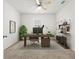 Bright home office featuring neutral walls, ceiling fan, desk, and decorative shelving at 3924 Candia Ave, North Port, FL 34286