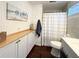 Bathroom features tiled shower, wainscoted walls, and wooden countertop at 415 Oakwood W Blvd, Sarasota, FL 34237