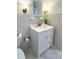 Well-lit bathroom with a white vanity, framed mirror, and tiled walls at 415 Oakwood W Blvd, Sarasota, FL 34237