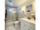Well-lit bathroom featuring a shower/tub combo with sliding glass doors and vanity at 415 Oakwood W Blvd, Sarasota, FL 34237