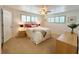 Bright bedroom features neutral walls, plush carpeting, and plantation shutters on windows at 415 Oakwood W Blvd, Sarasota, FL 34237