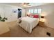 Bright bedroom features neutral walls, plush carpeting, and plantation shutters on windows at 415 Oakwood W Blvd, Sarasota, FL 34237