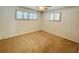This carpeted bedroom has two windows with blinds and a ceiling fan with lighting at 415 Oakwood W Blvd, Sarasota, FL 34237