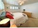 Bedroom with neutral walls, plush carpeting, and plantation shutters on windows at 415 Oakwood W Blvd, Sarasota, FL 34237